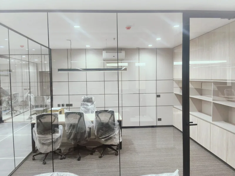 Office cabin with hi-wall split air conditioner, recessed downlights, pendant light and wall switch-socket plates