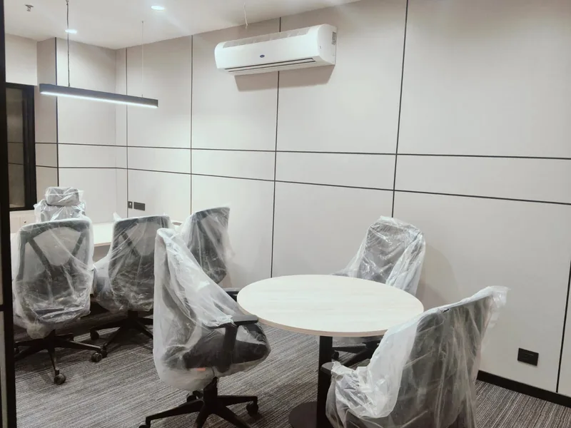 Meeting room with hi-wall split air conditioner, suspended linear light and ceiling smoke detector